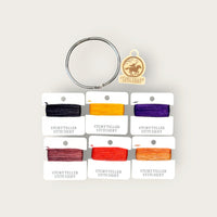 Headless Horseman Thread Set in Seren merino wool-silk: six hand-dyed thread cards in black, gold, purple, orange, and copper