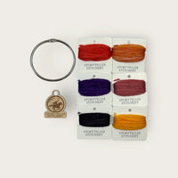 Headless Horseman Thread Set in Awen merino wool-silk: six hand-dyed thread cards in black, gold, purple, orange, and copper
