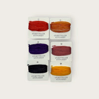 Headless Horseman Thread Set in Awen merino wool-silk: six hand-dyed thread cards in black, gold, purple, orange, and copper