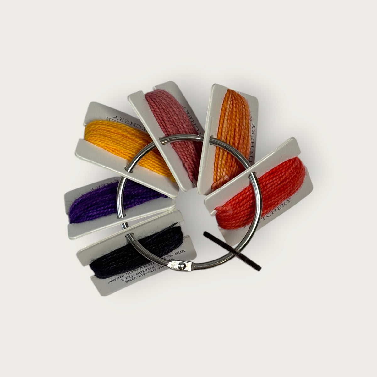Headless Horseman hand-dyed thread cards in black, purple, gold, orange, and copper with a silver ring and horseman charm