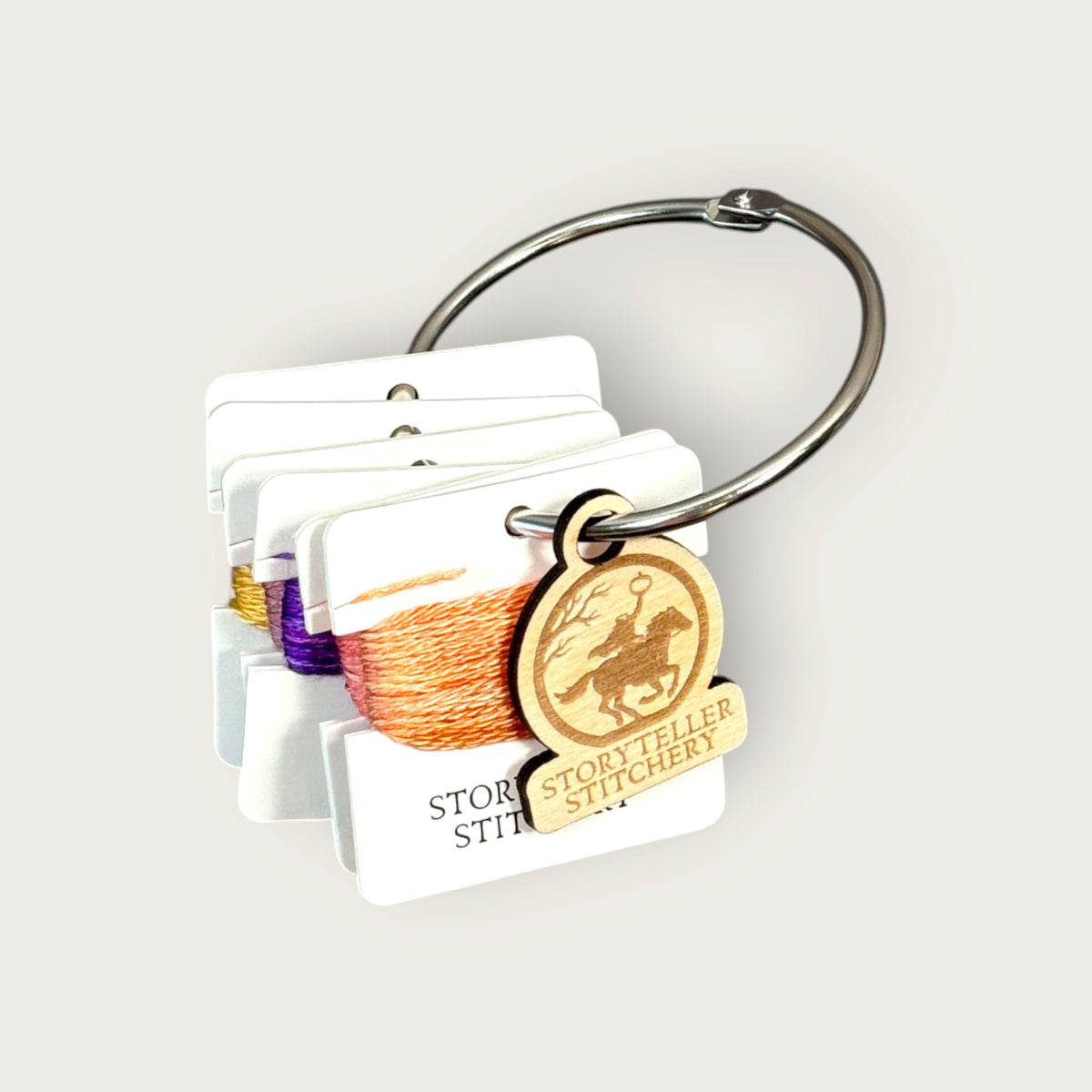 Headless Horseman hand-dyed thread cards in black, purple, gold, orange, and copper with a silver ring and horseman charm