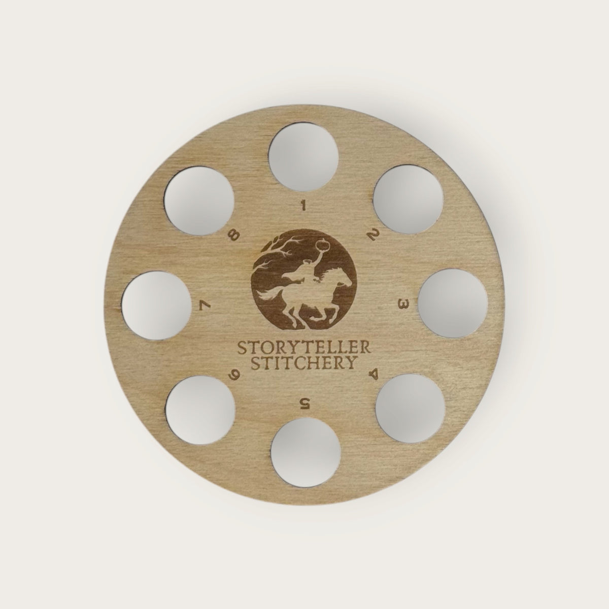 Round birch thread organizer with 8 numbered holes around an engraved Headless Horseman