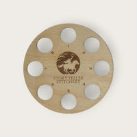 Round birch thread organizer with 8 numbered holes around an engraved Headless Horseman