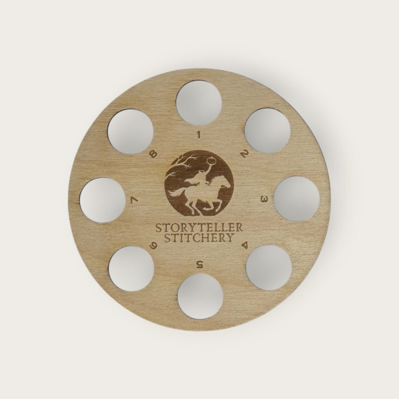 Round birch thread organizer with 8 numbered holes around an engraved Headless Horseman