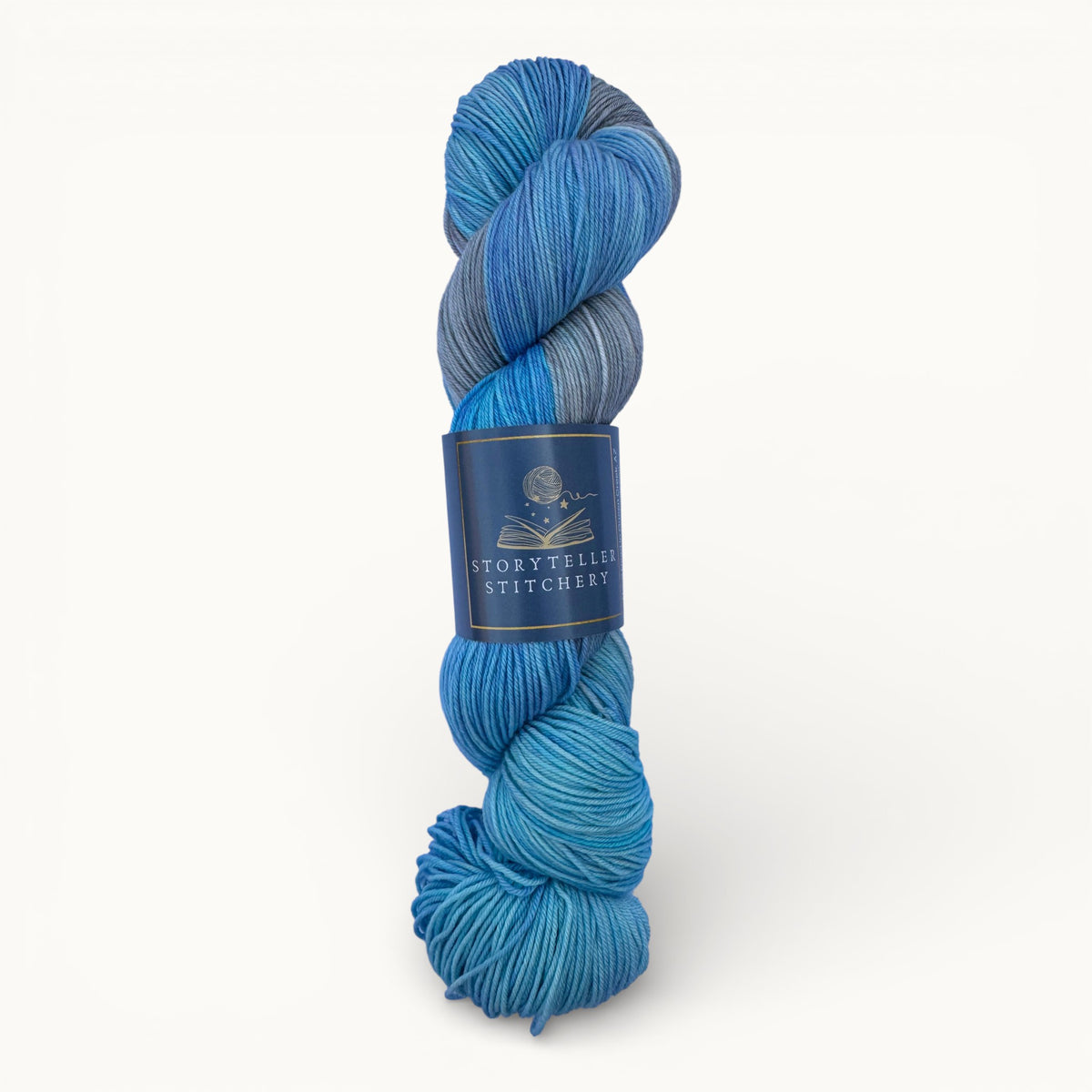 Blue skein of yarn with a label on a white background