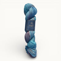 Blue skein of yarn with a label on a white background
