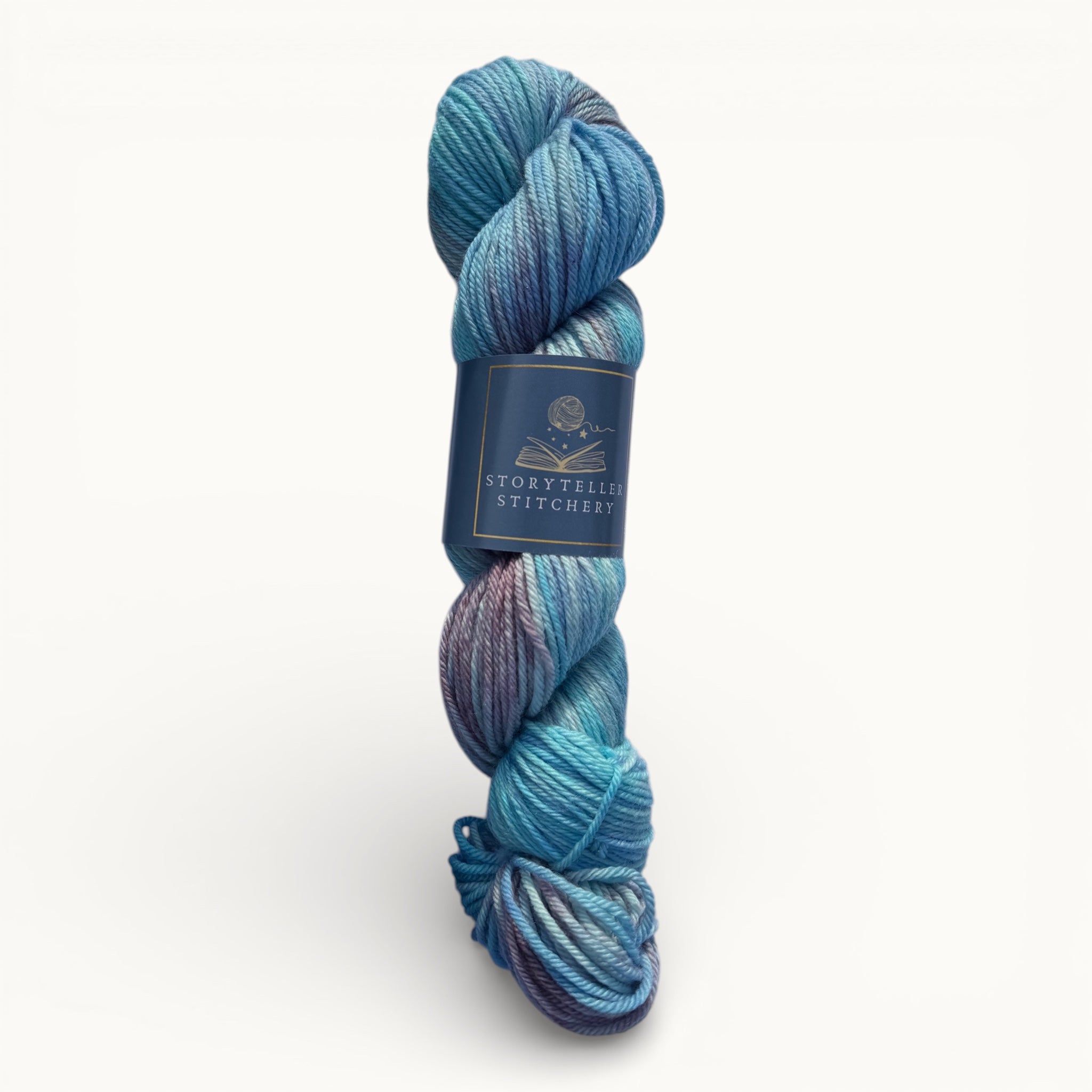 Blue skein of yarn with a label on a white background