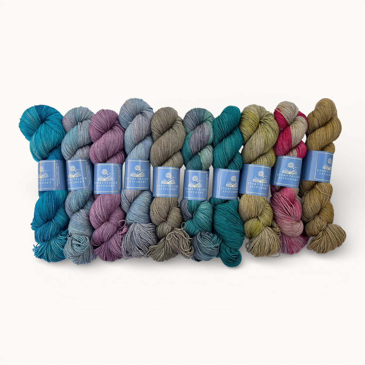 Set of colorful yarn skeins with labels on a white background