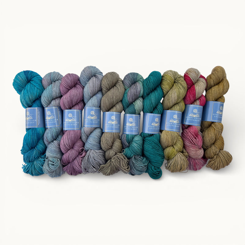 Set of colorful yarn skeins with labels on a white background