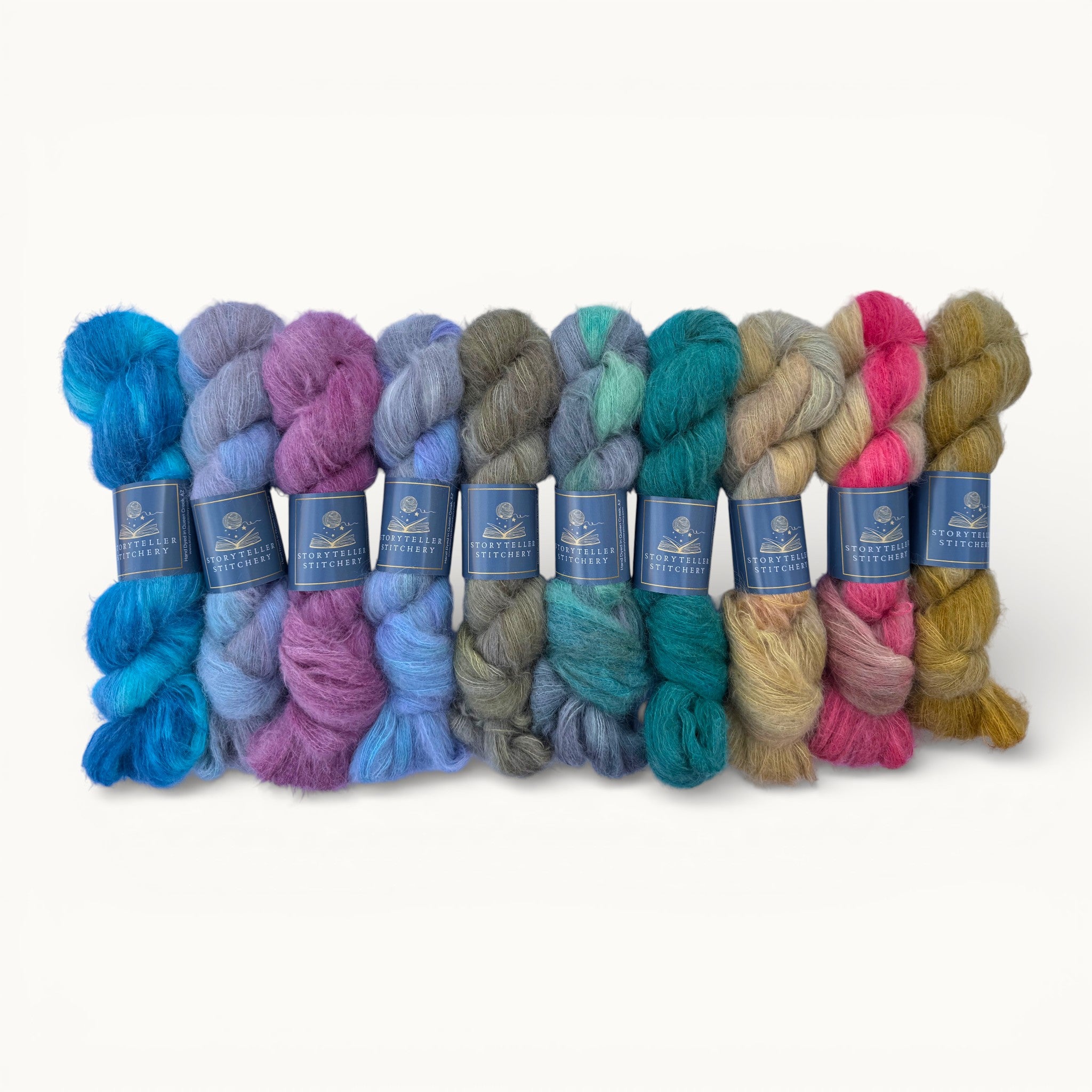Assorted skeins of yarn in various colors with labels on a white background