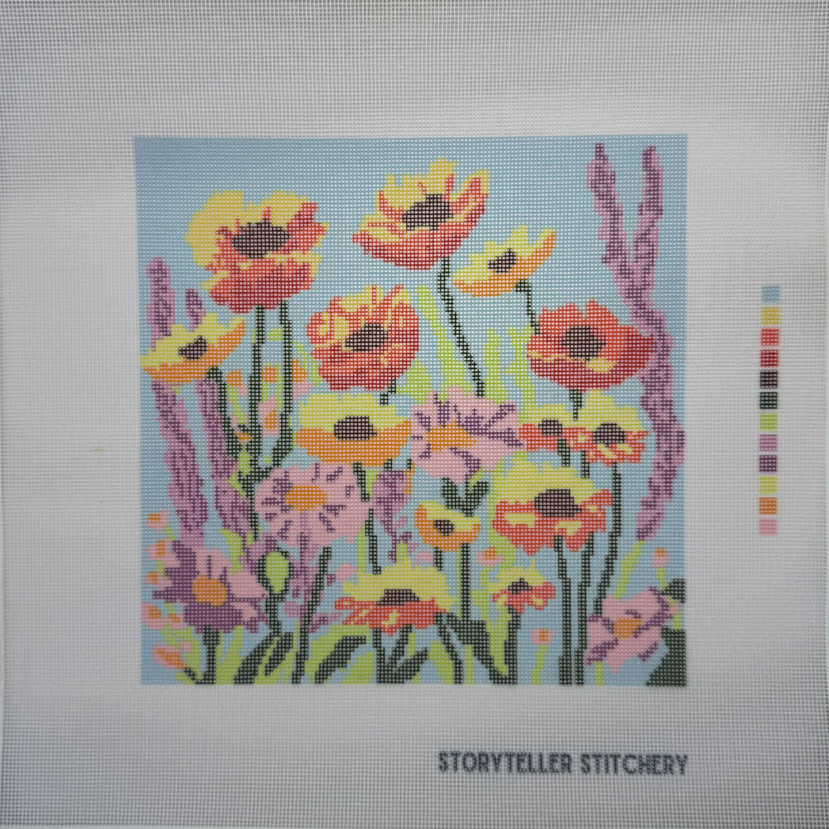 Colorful floral design on a needlepoint canvas with a color swatch by Storyteller Stitchery.